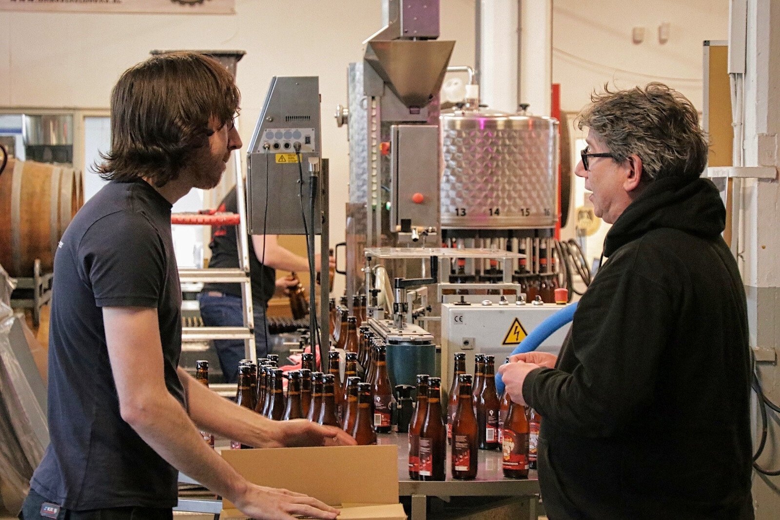 Rob Bours (to the right), head brewer and co-founder of 100 Watt Brewery 