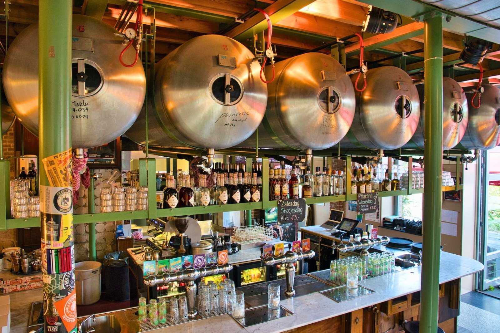 Beer tanks above the bar are used to store and dispense Poesiat & Kater beer