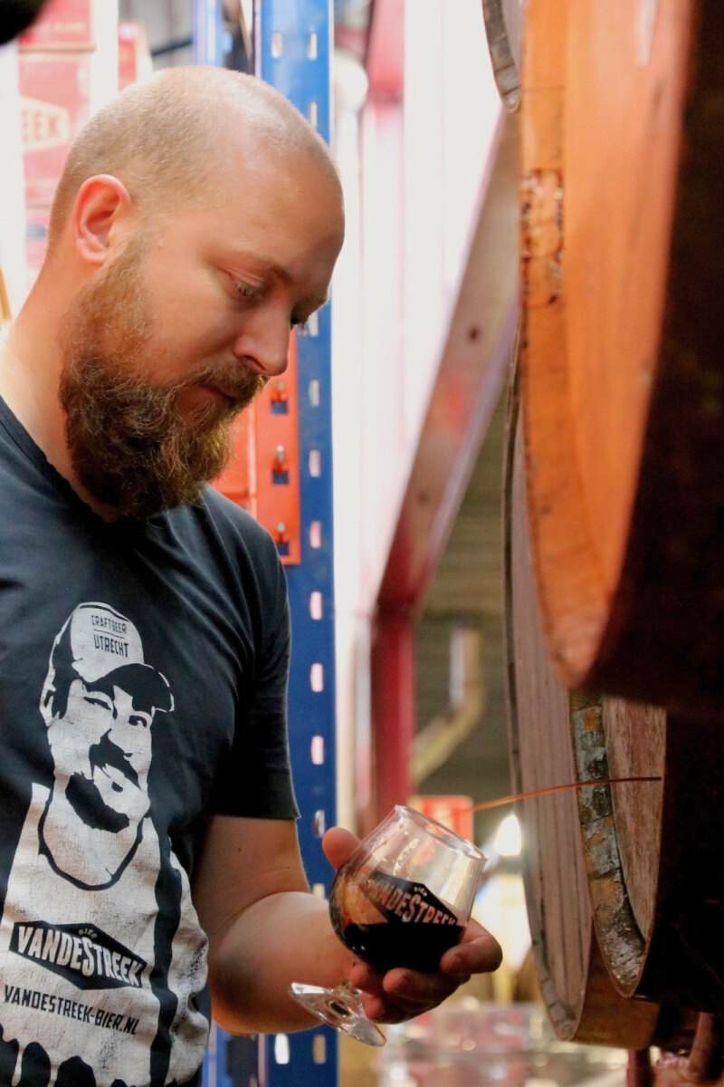 Sander van de Streek tasting a barrel aged VandeStreek beer