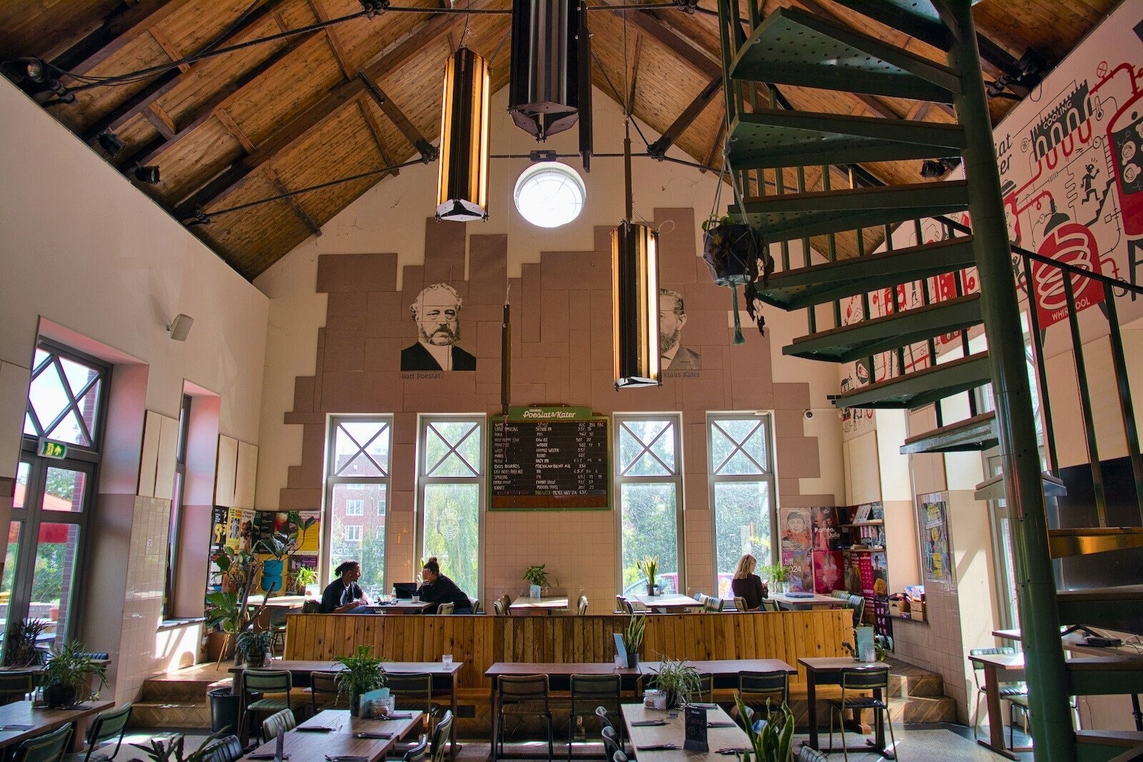 Portraits of Bart Poesiat and Klaas Kater on the wall of the tasting room