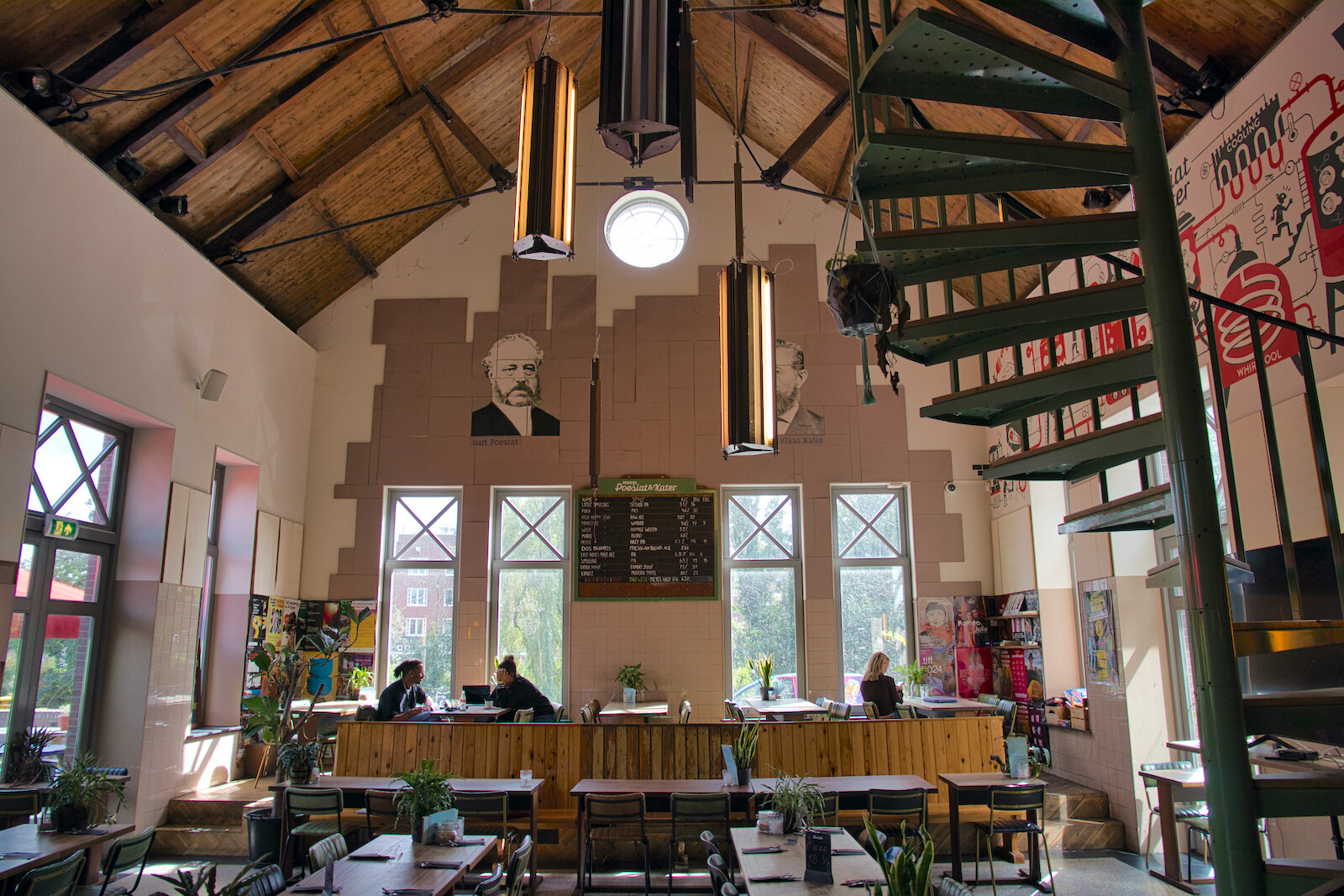 Portraits of Bart Poesiat and Klaas Kater on the wall of the brewpub